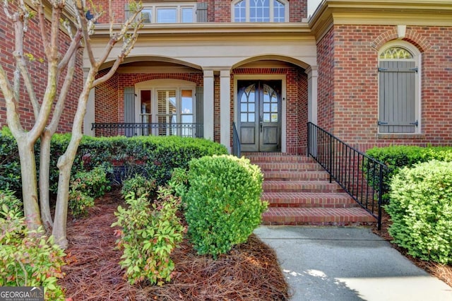 10125 Brixton Pl, Suwanee, GA 30024 - doorway to property featuring brick siding and covered porch