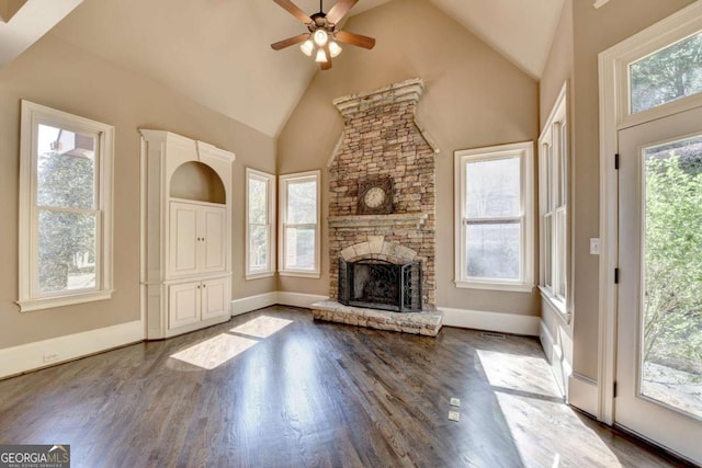10125 Brixton Pl, Suwanee, GA 30024 - unfurnished living room with a ceiling fan, wood finished floors, a stone fireplace, high vaulted ceiling, and baseboards