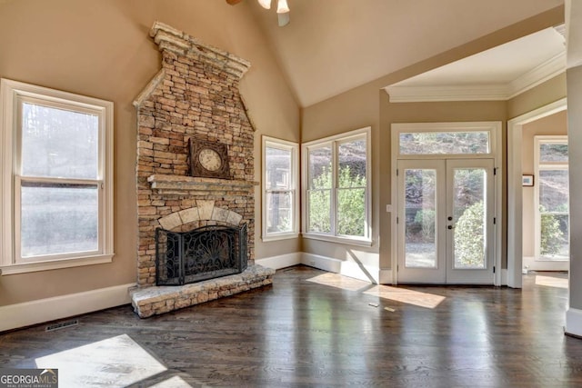 10125 Brixton Pl, Suwanee, GA 30024 - unfurnished living room featuring a fireplace, plenty of natural light, baseboards, wood finished floors, and high vaulted ceiling
