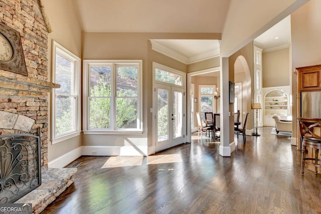 10125 Brixton Pl, Suwanee, GA 30024 - foyer with arched walkways, a fireplace, baseboards, wood finished floors, and a high ceiling