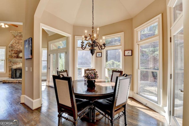 10125 Brixton Pl, Suwanee, GA 30024 - dining area featuring dark wood-style flooring, a chandelier, healthy amount of natural light, and vaulted ceiling