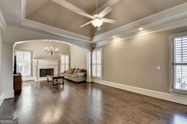 10125 Brixton Pl, Suwanee, GA 30024 - living area with plenty of natural light, arched walkways, a high end fireplace, and crown molding