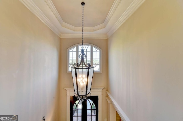 10125 Brixton Pl, Suwanee, GA 30024 - detailed view of a chandelier, a raised ceiling, and crown molding