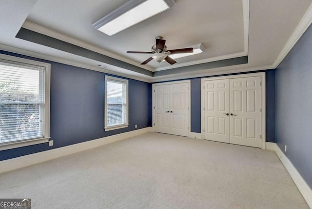 10125 Brixton Pl, Suwanee, GA 30024 - unfurnished bedroom with a tray ceiling, light carpet, ornamental molding, baseboards, and ceiling fan