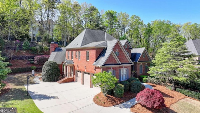 10125 Brixton Pl, Suwanee, GA 30024 - view of front facade featuring an attached garage, driveway, brick siding, and view of scattered trees