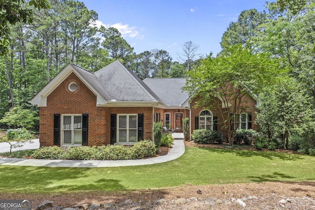 25 Highlands Way, Oxford, GA 30054 - view of front of home featuring brick siding, a front lawn, and roof with shingles