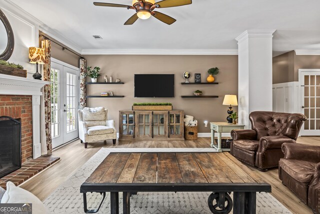 25 Highlands Way, Oxford, GA 30054 - living room featuring crown molding, french doors, ceiling fan, wood finished floors, and a brick fireplace
