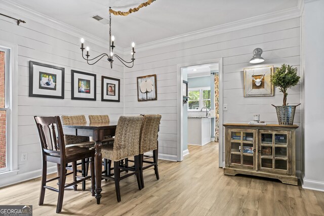 25 Highlands Way, Oxford, GA 30054 - dining area with crown molding, light wood-style flooring, a chandelier, and wooden walls