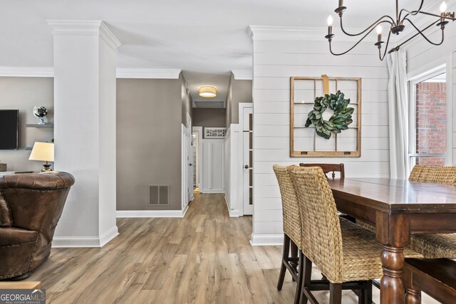 25 Highlands Way, Oxford, GA 30054 - dining space featuring light wood-style flooring, a chandelier, and ornamental molding