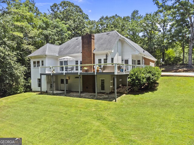 25 Highlands Way, Oxford, GA 30054 - back of house featuring a lawn, a wooden deck, a chimney, and an attached garage