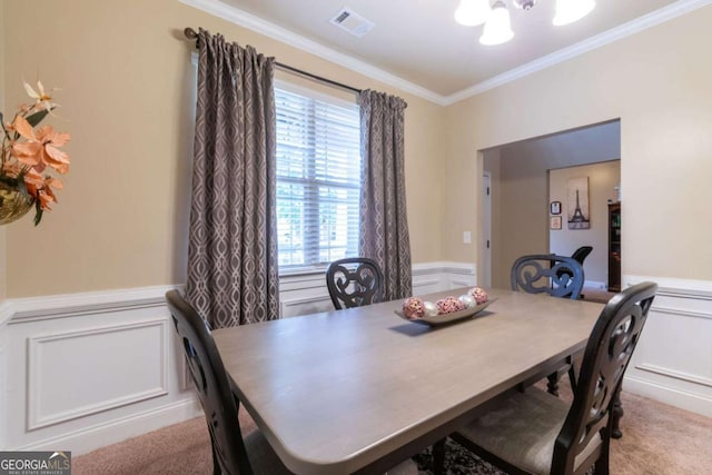 12275 Styron Dr, Hampton, GA 30228 - dining space featuring a chandelier, ornamental molding, wainscoting, a decorative wall, and light colored carpet