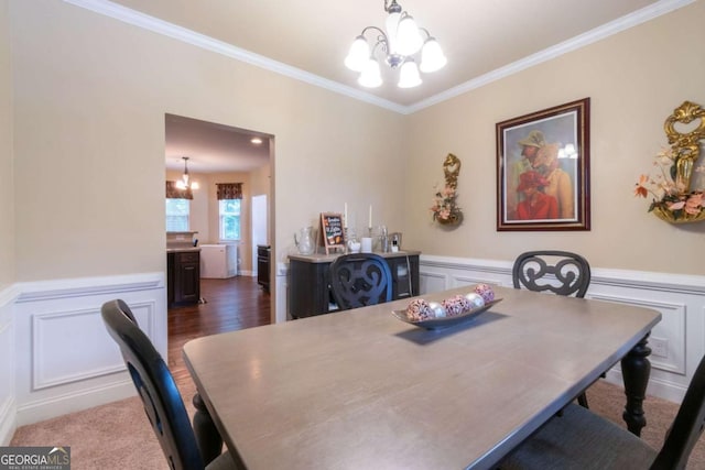 12275 Styron Dr, Hampton, GA 30228 - dining space with a chandelier, crown molding, a decorative wall, and a wainscoted wall