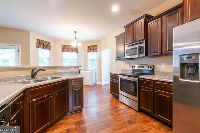 12275 Styron Dr, Hampton, GA 30228 - kitchen with stainless steel appliances, a chandelier, dark wood-style flooring, dark brown cabinetry, and light countertops