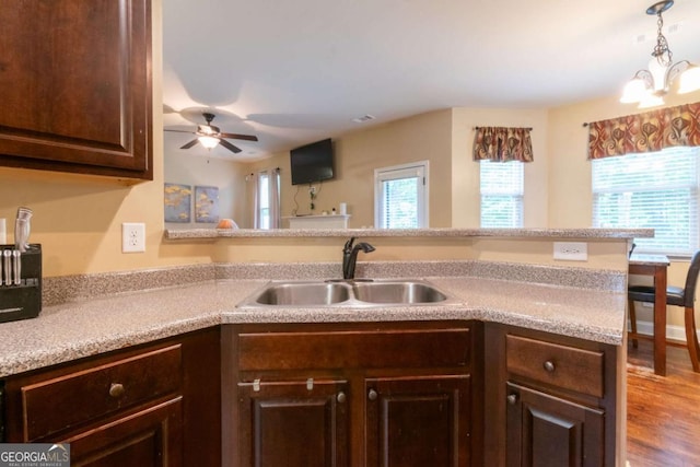 12275 Styron Dr, Hampton, GA 30228 - kitchen featuring dark brown cabinets, a ceiling fan, light countertops, and a chandelier