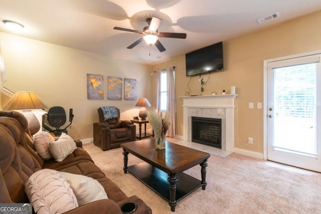 12275 Styron Dr, Hampton, GA 30228 - living area with light colored carpet, a ceiling fan, and a high end fireplace