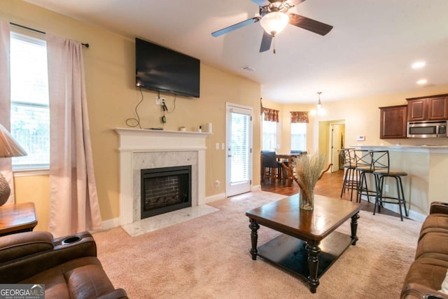 12275 Styron Dr, Hampton, GA 30228 - living area featuring plenty of natural light, light carpet, ceiling fan, and a high end fireplace