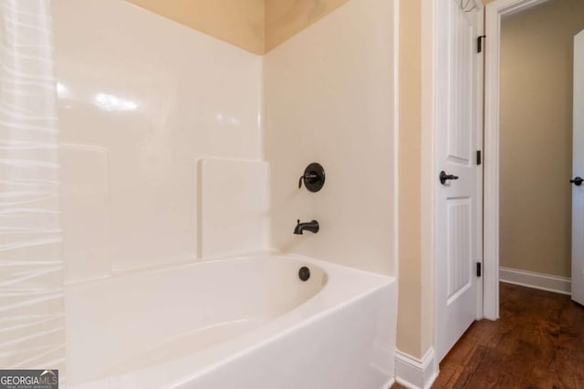 12275 Styron Dr, Hampton, GA 30228 - bathroom with wood finished floors and bathing tub / shower combination