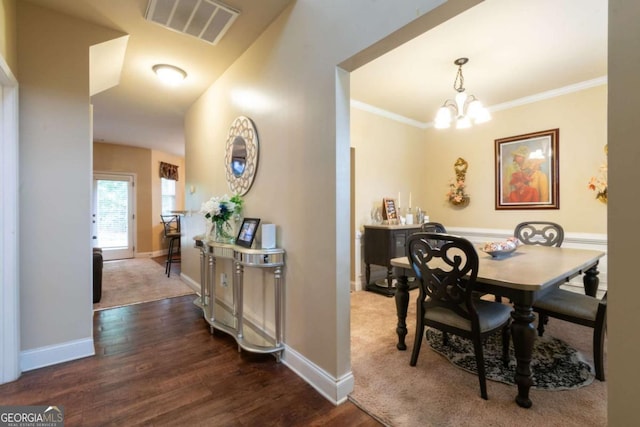 12275 Styron Dr, Hampton, GA 30228 - dining area with wood finished floors, a chandelier, and crown molding