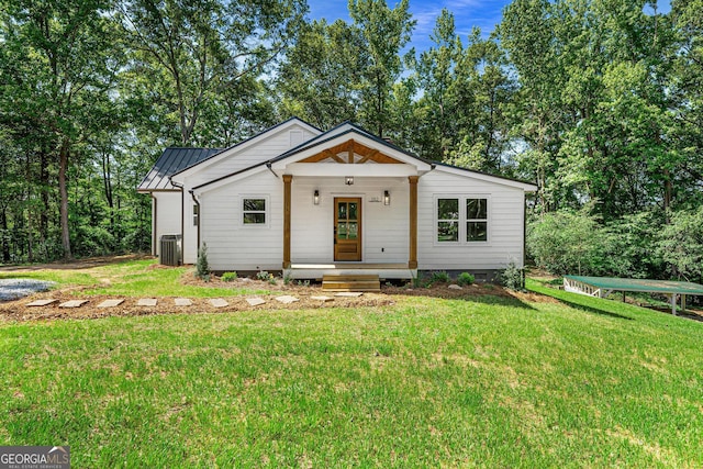 182 Cherry Rose Ln, Hartwell, GA 30643 - modern inspired farmhouse featuring a front yard, central AC unit, metal roof, and view of wooded area