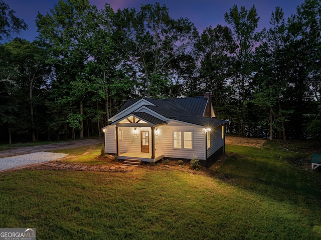 182 Cherry Rose Ln, Hartwell, GA 30643 - bungalow-style home with a front yard, metal roof, a chimney, gravel driveway, and a wooden deck