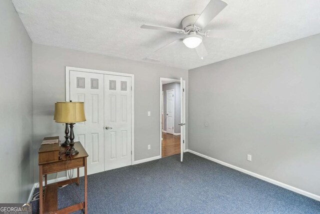 2201 Colonial Oak Way, Stone Mountain, GA 30087 - bedroom with carpet, a closet, baseboards, a ceiling fan, and a textured ceiling