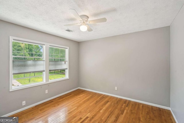 2201 Colonial Oak Way, Stone Mountain, GA 30087 - empty room with baseboards, wood finished floors, ceiling fan, and a textured ceiling