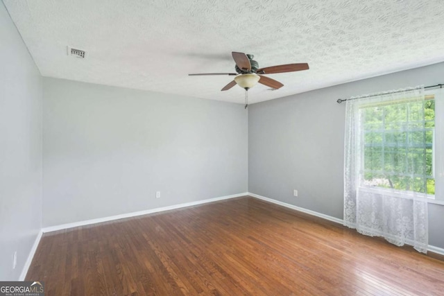 2201 Colonial Oak Way, Stone Mountain, GA 30087 - spare room featuring wood finished floors, baseboards, ceiling fan, and a textured ceiling