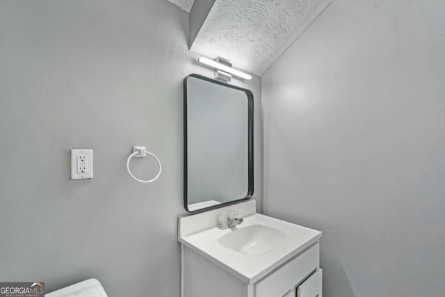 2201 Colonial Oak Way, Stone Mountain, GA 30087 - bathroom with vanity, toilet, and a textured ceiling