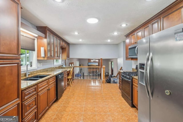 2201 Colonial Oak Way, Stone Mountain, GA 30087 - kitchen with black appliances, a sink, light stone countertops, recessed lighting, and glass insert cabinets