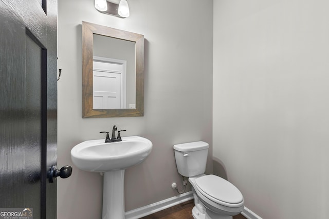 74 Riverwood Trl, Grantville, GA 30220 - bathroom with toilet, baseboards, and wood finished floors