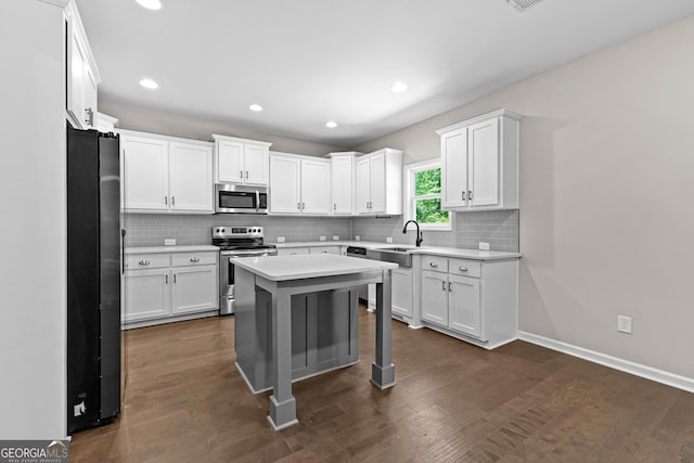 74 Riverwood Trl, Grantville, GA 30220 - kitchen featuring appliances with stainless steel finishes, light countertops, tasteful backsplash, white cabinetry, and recessed lighting
