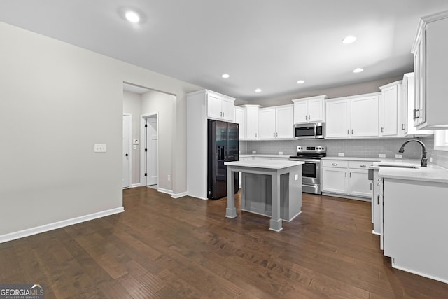 74 Riverwood Trl, Grantville, GA 30220 - kitchen featuring stainless steel appliances, tasteful backsplash, light countertops, a center island, and recessed lighting