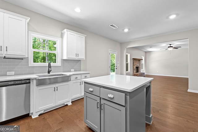 74 Riverwood Trl, Grantville, GA 30220 - kitchen featuring stainless steel dishwasher, a sink, gray cabinetry, light countertops, and white cabinets