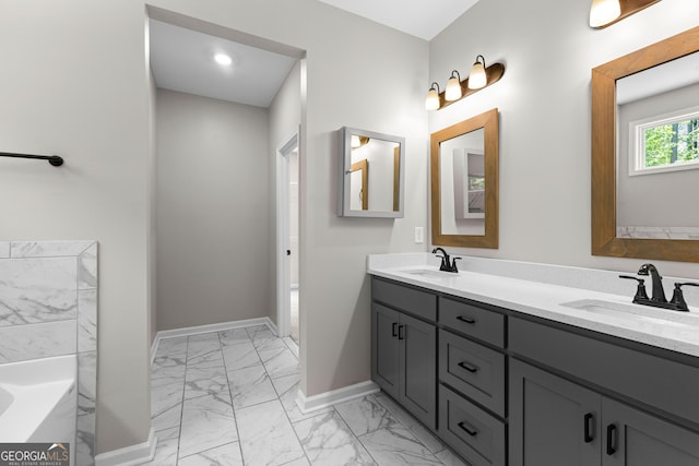 74 Riverwood Trl, Grantville, GA 30220 - bathroom featuring marble look tiles, double vanity, a tub, and baseboards