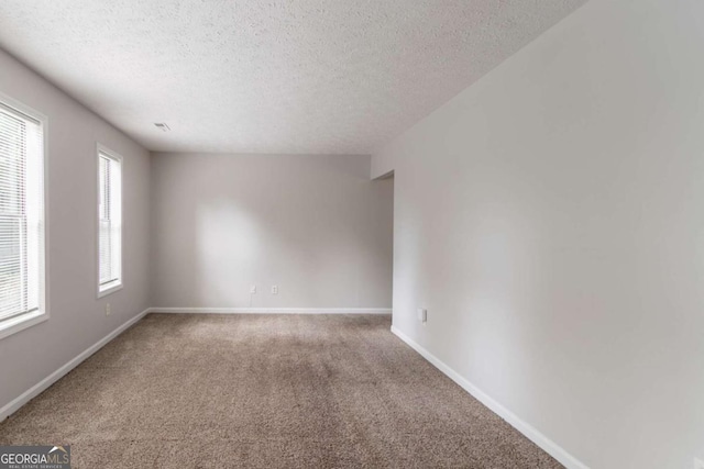 3851 Natalie Way, Ellenwood, GA 30294 - carpeted spare room with a textured ceiling and baseboards