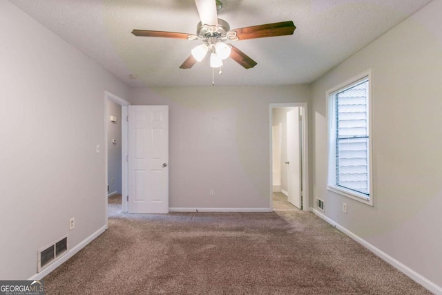 3851 Natalie Way, Ellenwood, GA 30294 - unfurnished bedroom with carpet, a textured ceiling, ceiling fan, and connected bathroom