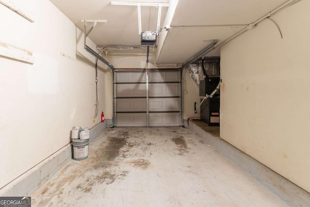 3851 Natalie Way, Ellenwood, GA 30294 - garage featuring a garage door opener and heating unit