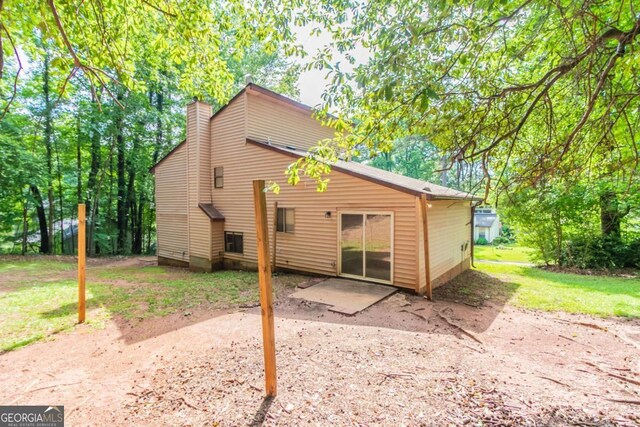 3851 Natalie Way, Ellenwood, GA 30294 - back of property with a chimney and a patio area