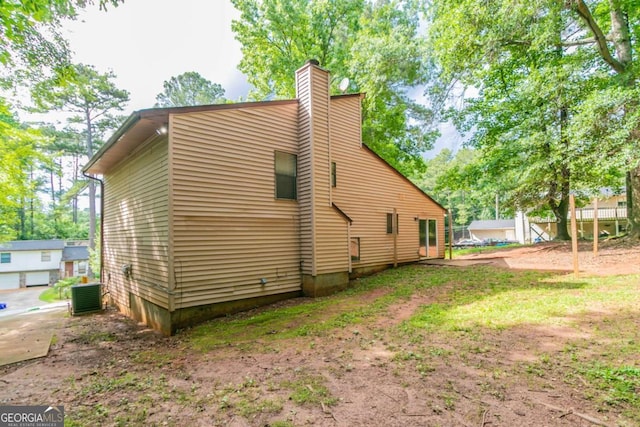 3851 Natalie Way, Ellenwood, GA 30294 - view of side of home featuring a chimney and a cooling unit