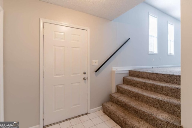 3851 Natalie Way, Ellenwood, GA 30294 - foyer entrance with stairs, light tile patterned floors, and a textured ceiling