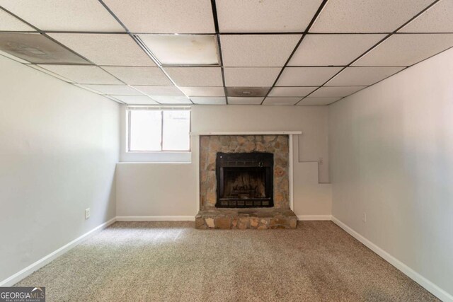 3851 Natalie Way, Ellenwood, GA 30294 - unfurnished living room with carpet floors, a stone fireplace, and a paneled ceiling