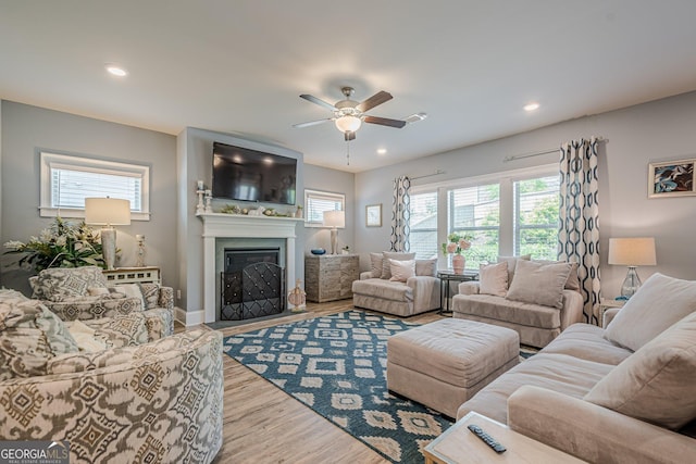 3715 Bridges Ct, Cumming, GA 30040 - living area with ceiling fan, wood finished floors, a fireplace with flush hearth, and recessed lighting