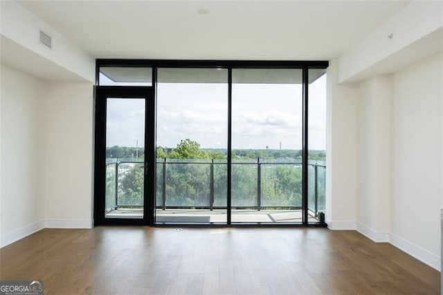 788 Marietta St Unit 311, Atlanta, GA 30318 - empty room with a wall of windows and wood finished floors