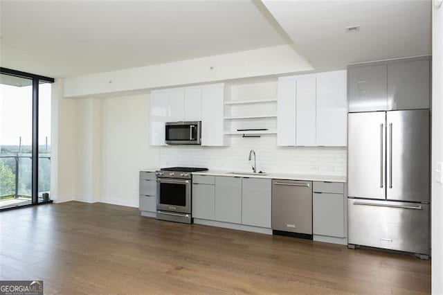 788 Marietta St Unit 311, Atlanta, GA 30318 - kitchen featuring high end appliances, open shelves, floor to ceiling windows, tasteful backsplash, and light countertops