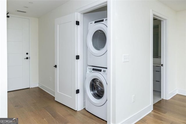 788 Marietta St Unit 311, Atlanta, GA 30318 - washroom featuring stacked washing machine and dryer and wood finished floors