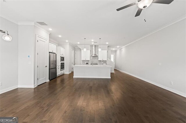 240 Walker Ave, Roswell, GA 30076 - unfurnished living room featuring a ceiling fan, dark wood-type flooring, crown molding, and recessed lighting