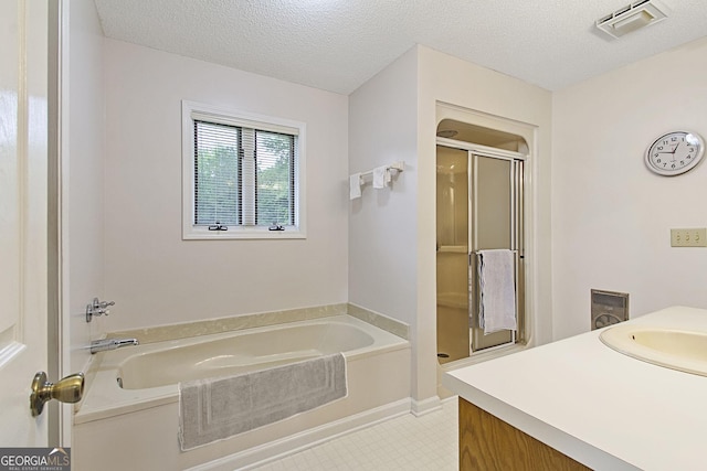 118 Hidden Hills Dr, Macon, GA 31217 - full bath with a stall shower, a bath, vanity, and a textured ceiling