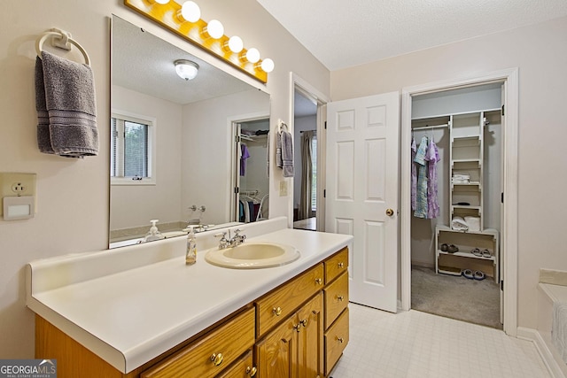 118 Hidden Hills Dr, Macon, GA 31217 - full bath featuring a spacious closet, vanity, and a textured ceiling