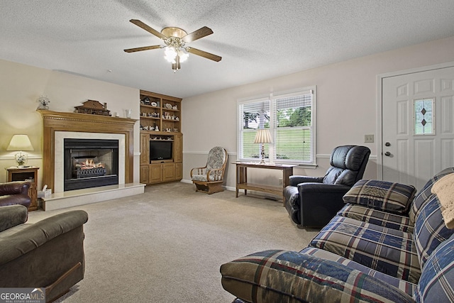 118 Hidden Hills Dr, Macon, GA 31217 - living area with a ceiling fan, light colored carpet, a lit fireplace, and a textured ceiling