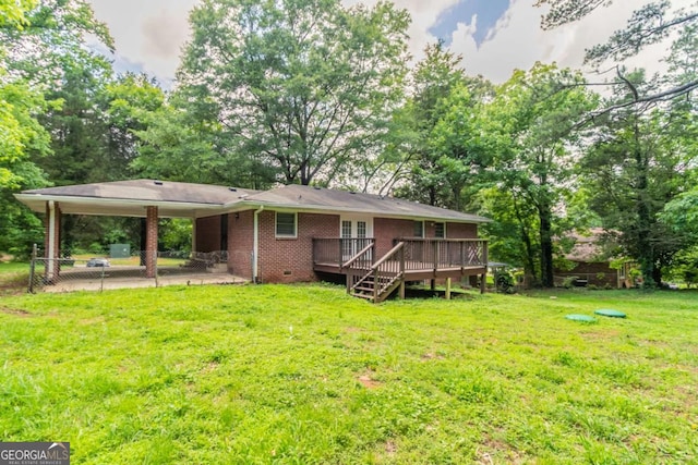 4078 Bouldercrest Rd, Ellenwood, GA 30294 - back of house with an attached carport, a deck, brick siding, and a yard